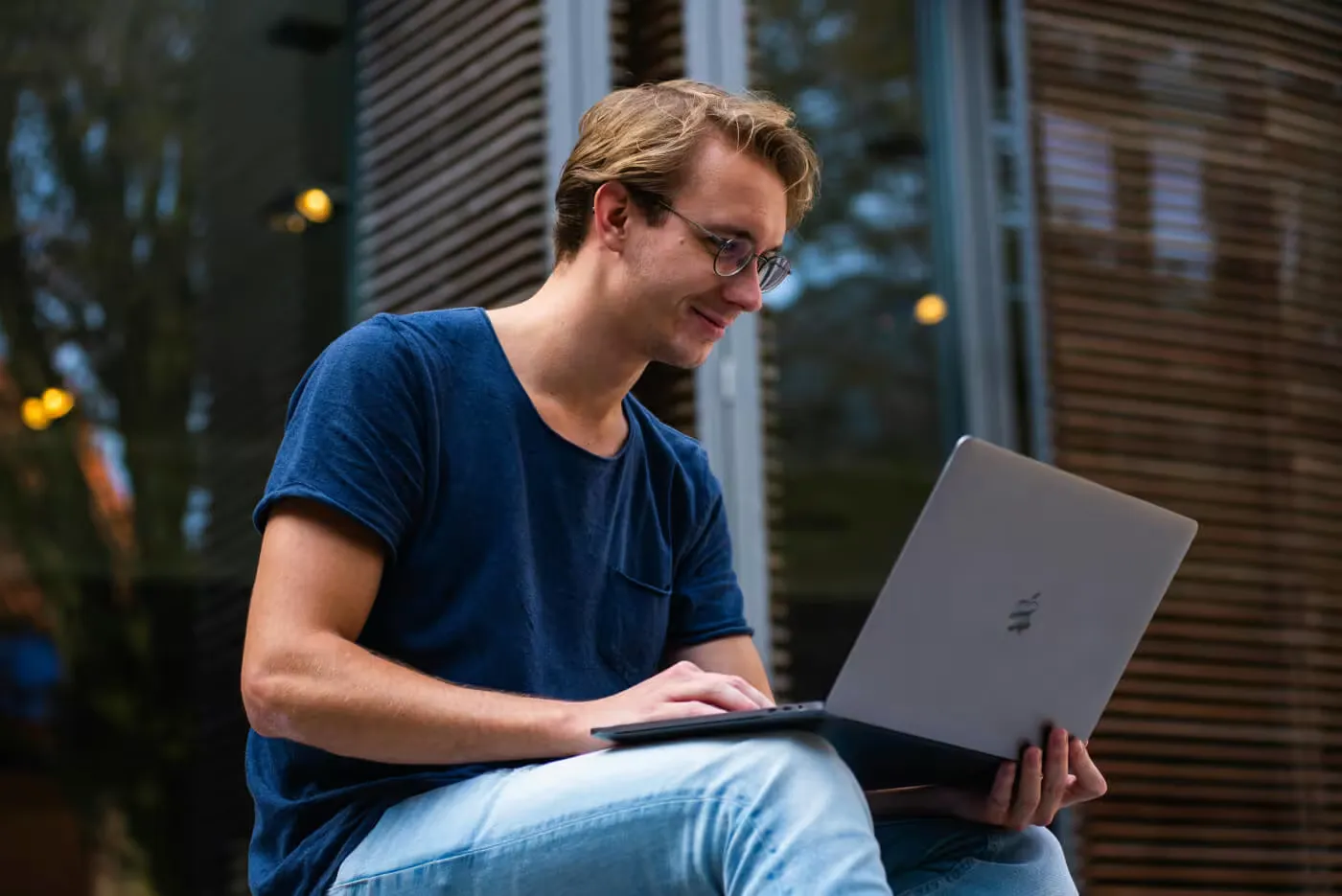 Young man listening to lecture on laptop
