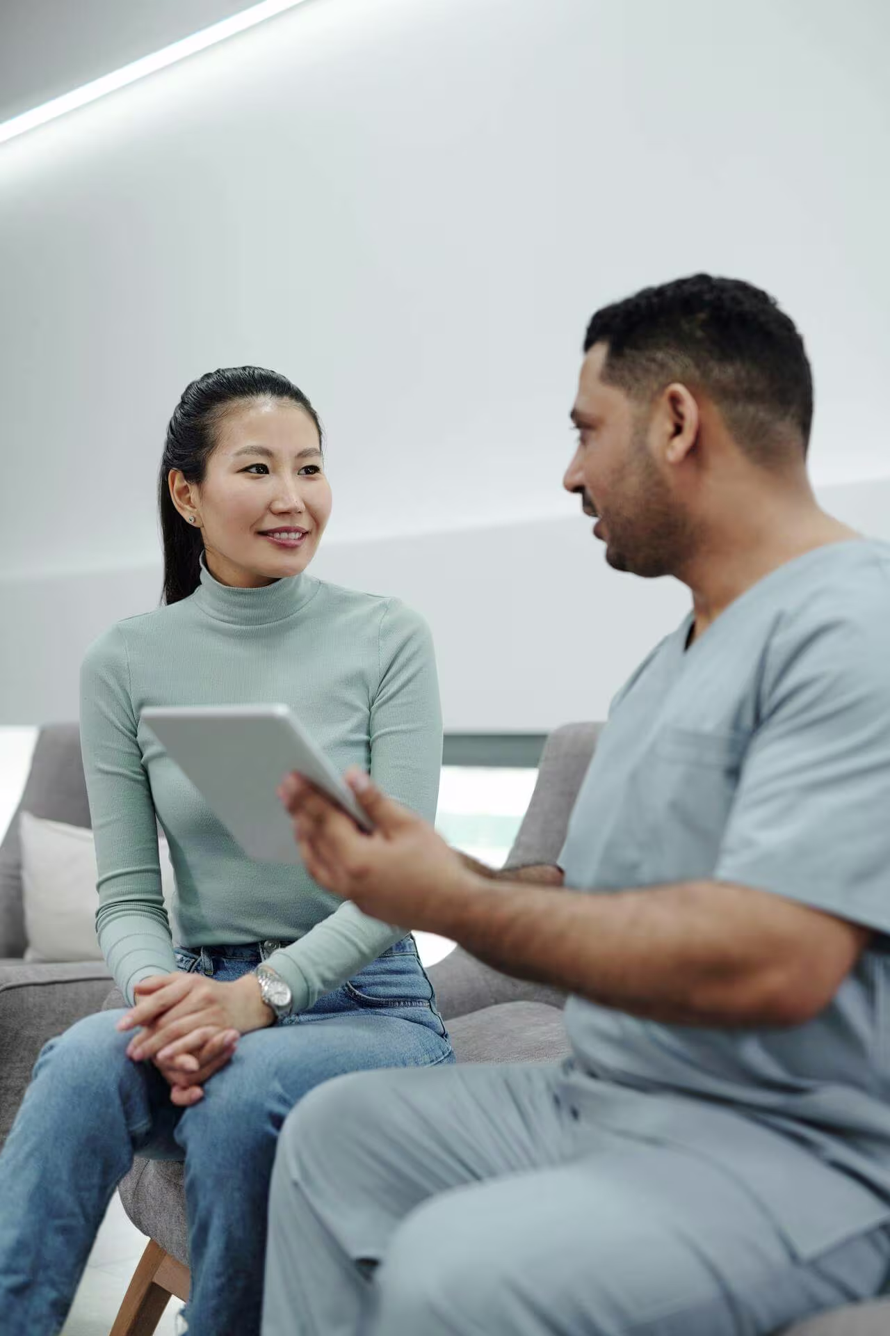 Therapist doing patient consultation before massage session
